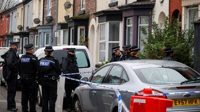 Police officers gather outside a house in the Kensington area in Liverpool where counterterrorism officers arrested three men. Reuters