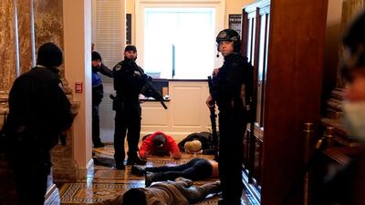 US Capitol Police stand detain protesters outside of the House Chamber during a joint session of Congress. AFP