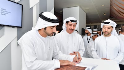 Sheikh Hamdan signs the guestbook.