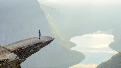 Hiker standing on Trolltunga at Odda, Hordaland county, Norway