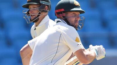 Australian batsmen Shaun Marsh, right, and Adam Voges take runs on Thursday during Day 1 of the first Test against West Indies. William West / AFP / December 10, 2015