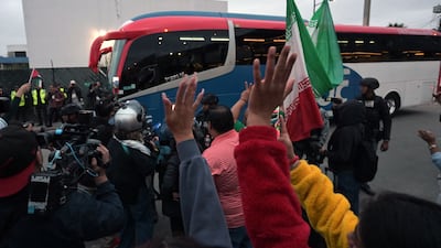 Football fans cheer as Iran's players leave the Tijuana International Airport on a bus. AFP