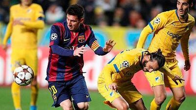 Barcelona's Argentinian forward Lionel Messi, left, passes the ball ahead of Apoel's Cypriot midfielder Stathis Aloneftis during their UEFA Champions League football match at the Neo GSP Stadium in the Cypriot capital, Nicosia, on November 25, 2014.AFP PHOTO/ SAKIS SAVVIDES