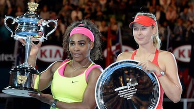 Serena Williams, left, of the US and Russia's Maria Sharapova hold their trophies after Williams won their women's singles final at the 2015 Australian Open tennis tournament in Melbourne. AFP PHOTO / MAL FAIRCLOUGH