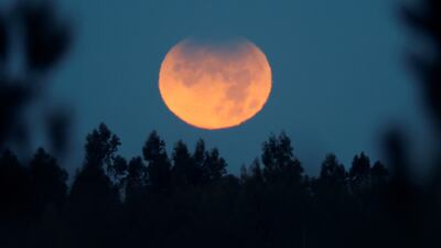 The Moon, with its upper hemisphere partially eclipsed, over Monte Pedroso, in Santiago de Compostela, north-west Spain, early on the morning of November 19, 2021. EPA