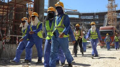 Foreign workers leaving a construction site in Doha, Qatar. Amnesty released a report on November 12 urging the country to speed up its reforms on labour. EPA