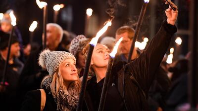 Members of the public take part during the torchlight procession on Edinburgh's Royal Mile for the start of the Hogmanay celebrations. Getty