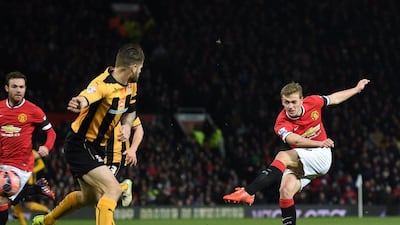 Manchester United's James Wilson shoots and scores their final goal in a 3-0 FA Cup fourth round replay win over Cambridge United on Tuesday. Paul Ellis / AFP