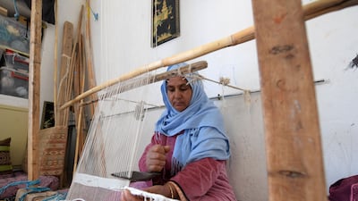 A craftswoman weaves a rug in the Tunisian oasis of Nefta, at a workshop run by Shanti, a social enterprise that helps artisans in the North African country. All photos: AFP