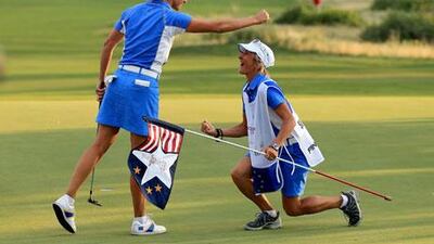 Giulia Sergas celebrates with Nadia Bortoluzzi, her caddie, on the 18th green during the final day singles matches in the Solheim Cup. David Cannon / Getty Images / AFP