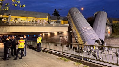 Two wagons on a road in Munich, Germany, after a freight train derailed on a bridge following a collision. Reuters