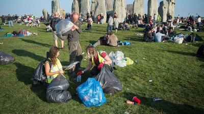 People begin to clear up following the Summer Solstice sunrise at Stonehenge. Tim Ireland / Getty Images