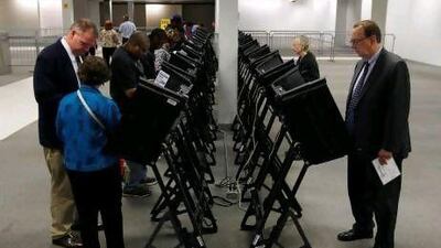 Voters cast their ballots at a Franklin County polling site on Tuesday, on the first day of absentee voting in Columbus, Ohio.