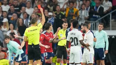 Referee Guillermo Cuadra Fernandez shows a red card to Osasuna's David Garcia. AP