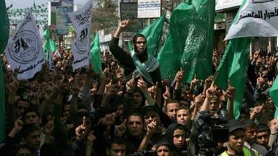 Palestinian supporters of Gaza's ruling Hamas government shout slogans and wave their party's green flags during a protest in Rafah today.