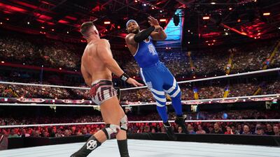 Austin Theory and Angelo Dawkins square off in the ring during their six-man tag team match.