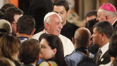Pope Francis smiles during a mass near River Jordan on May 24, 2014. The pontiff called for urgent steps to end Syria’s three-year civil war as he arrived in neighbouring Jordan on the first leg of his Middle East tour aimed at bringing hope to the region’s dwindling Christian population. Ali Jarekj/Reuters