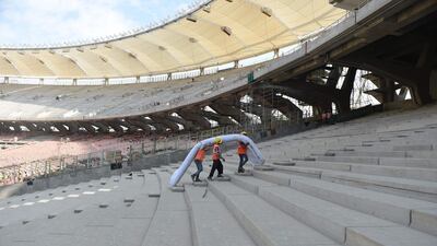 Workers at the construction site of the world's largest cricket stadium in Motera. AFP