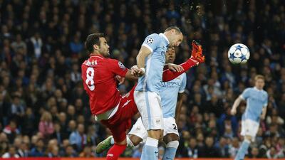 Sevilla’s Vicente Iborra and Manchester City’s Pablo Zabaleta challenge for the ball during their Champions League match on Wednesday. Phil Noble / Reuters