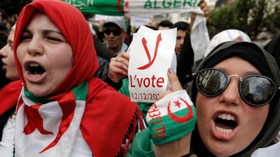 An Algerian student holds a poster reading "No to the vote on Dec.12" during a protest in Algiers. AP Photo