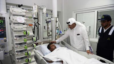 An official from the Saudi Arabian health ministry talks to a victim who was injured in the haj stampede, as he visits a hospital in Mecca. Saudi Press Agency via AP