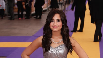 Demi Lovato, in a strapless silver dress, arrives at the premiere of 'Hannah Montana: The Movie' at the Odeon on April 23, 2009 in London, England. Getty Images