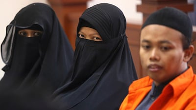 Dian Yulia Novi (C) is sentenced to seven-and-a-half years for her involvement in an ISIL-inspired plot to carry out an attack on the presidential palace in Jakarta. In this picture, she is seen sitting next to her husband, Nur Solihin (R), and her recruiter, Tutin Sugiarti, during their trial hearing in East Jakarta District Court on August 23, 2017. Achmad Ibrahim / The Associated Press