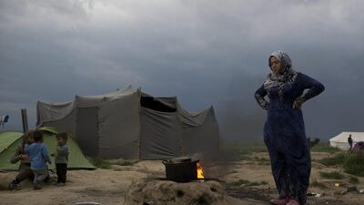 A Syrian woman cooks at a refugee camp on the northern Greek border point of Idomeni. Petros Giannakouris / AP Photo