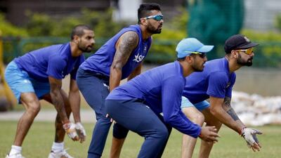 India cricket team captain Virat Kohli, right, and teammates, from left, Shikhar Dhawan, Murali Vijay and Shardul Thakur take their positions to catch the ball on the last day of team’s six day training camp at National Cricket Academy in Bangalore, India, Monday, July 4, 2016. Aijaz Rahi / AP Photo