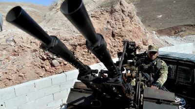 Fighters with the Free Syrian Army patrol the outskirts of the northern town of Jisr al-Shughur. DHA via AP