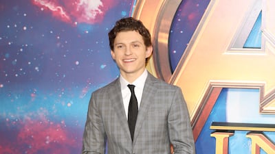 Tom Holland, in a grey suit, attends a UK 'Avengers: Infinity War' fan event in London on April 8, 2018. Getty Images