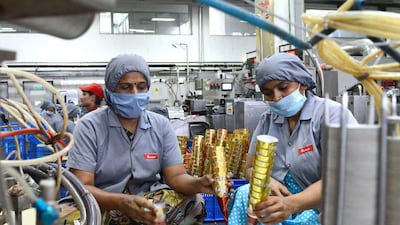 Factory workers place ice cream cones on the production line at the Havmor Ice Cream plant at Naroda near Ahmedabad. While these frozen treats are hugely popular in India especially during summer, the hours-long power cuts during during this period make it difficult for ice cream makers to sell their products in rural areas. Sam Panthaky / AFP