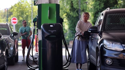 Customers refuel vehicles at a petrol station in Buckinghamshire, northwest of London. Petrol prices in the UK have reached their highest level of 2026, driven by the war in Iran. EPA