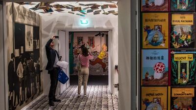 Visitors walk past album covers of the adventures of comic character Tintin on display at the Herge exhibition at the Grand Palais in Paris, France on September 26, 2016. The exhibition on Belgian cartoonist Georges Remi, who wrote under the name Herge, runs from 28 September to 14 January 2017. Christophe Petit Tesson/EPA