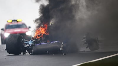 Logan Sargeant's Williams in flames after his crash during practice. Getty Images