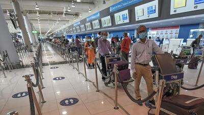 Indian citizens queue to check in at the Dubai International Airport before leaving the UAE on a flight back to their home country on May 7. Inbound flights for UAE residents have also begun operating from select cities. Karim Sahim / AFP