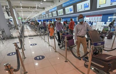 Indian citizens queue to check in at the Dubai International Airport before leaving the UAE on a flight back to their home country on May 7. Inbound flights for UAE residents have also begun operating from select cities. Karim Sahim / AFP