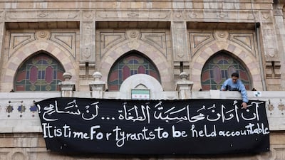 A protest in Damascus on December 27. At least 15,000 people died from torture or were killed in the government’s prisons during Syria's civil war. AFP