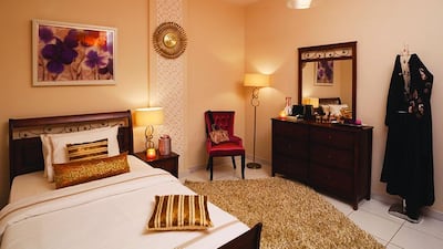 AFTER — Stylist solutions: Nabila Albloushi’s 18-year-old daughter, Salma, was living in a room that didn’t really reflect her personality. Her walls were painted bright red and her furniture was all the same colour. In addition, her room was small, with an unsightly, exposed concrete pillar. What she wanted was a modern room that was cosy, relaxing and inviting to friends, and that featured some of her favourite colours: pink, purple, gold and silver. Since the space was small, the stylist started by painting the walls in white and light beige to make it feel bigger. Furniture was selected carefully to match Salma’s personality and give the room a warmer feel. The stylist introduced a Tango Purple Arm Chair that brought a pop of one of her favourite colours into the space and introduced velvet for a touch of elegance. The concrete pillar in the centre of the room took up valuable space but the stylist used this structure to divide the room in two, with one side acting as the bedroom and the other as a living space featuring the accent chair, where Salma could sit and read. As a finishing touch, textured wall art was included to lend the room a softer, more feminine feel.