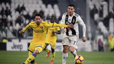Frosinone's Edoardo Goldaniga holds off Juventus' Cristiano Ronaldo. AFP