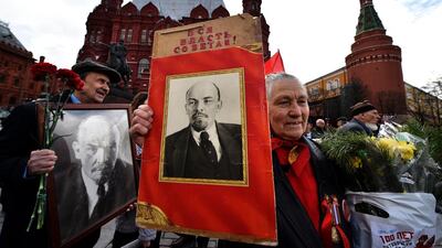 Russian communist party supporters hold pictures of Vladimir Lenin as they attend a wreath-laying ceremony to mark the founding Soviet leader’s birthday at Red Square in Moscow. Yuri Kadabnov / AFP Photo