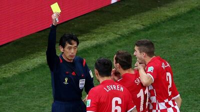 Japanese referee Yuichi Nishimura shows Dejan Lovren a yellow card, awarding Brazil a penalty in their win over Croatia on Thursday night. Elsa / Getty Images / June 12, 2014