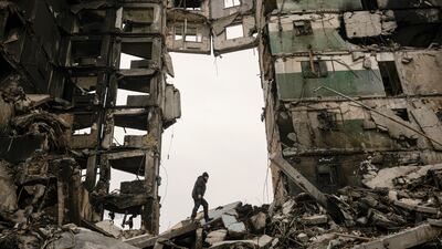 A resident searches for belongings in an apartment building destroyed during fighting in Borodyanka, Ukraine, on April 5. AP