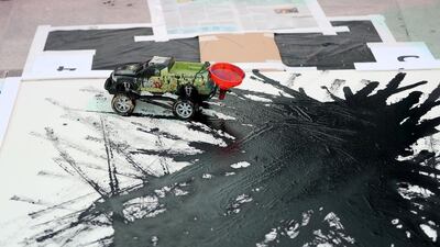 Artist Sharan Anil creates art using a remote control car.