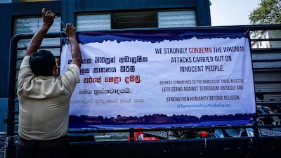 A security guard fixes a sign of solidarity from Muslims to the victims on Sundays bomb attacks, in Colombo, Sri Lanka, April 24, 2019. Jack Moore / The National