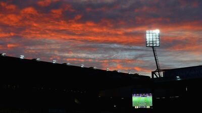 The sky lights up red as the sun sets over Vicarage Road on Saturday during the Premier League match between Watford and Arsenal. Ross Kinnaird / Getty Images