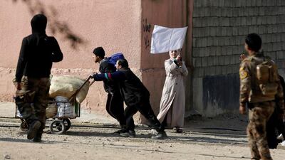 A woman waves a white flag in Mosul, Iraq.