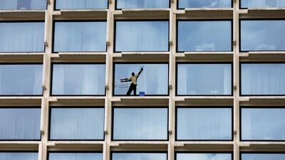 A worker cleans the windows of a luxury hotel in Colombo, Sri Lanka. Dinuka Liyanawatte / Reuters