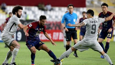 Leonardo, centre, was the star for Al Wahda against Al Rayyan, scoring all four goals in their thrilling victory. AFP