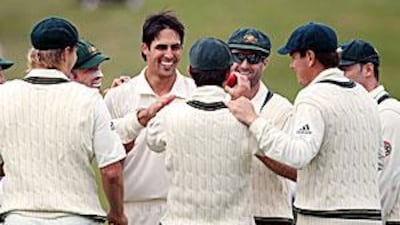 Mitchell Johnson celebrates the fall of Martin Guptill with his teammates.